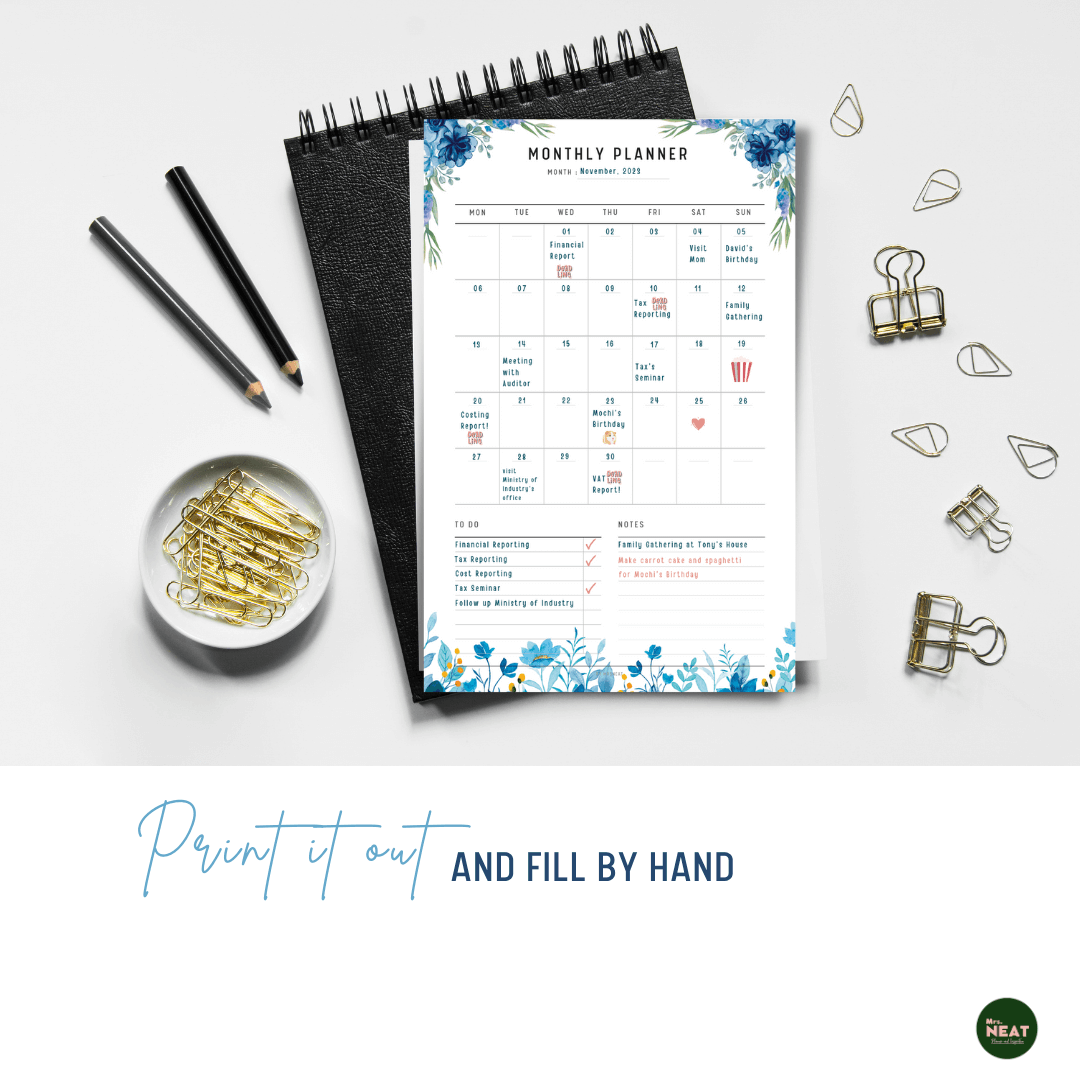 Blue Floral Monthly Planner Printable printed out on the paper with stationery surround
