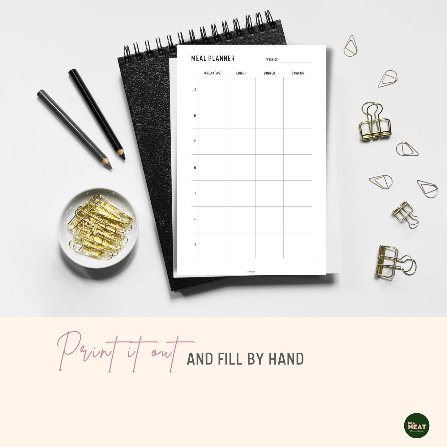 Weekly Meal Planner Printable printed out on paper and put on the black book with stationery surround