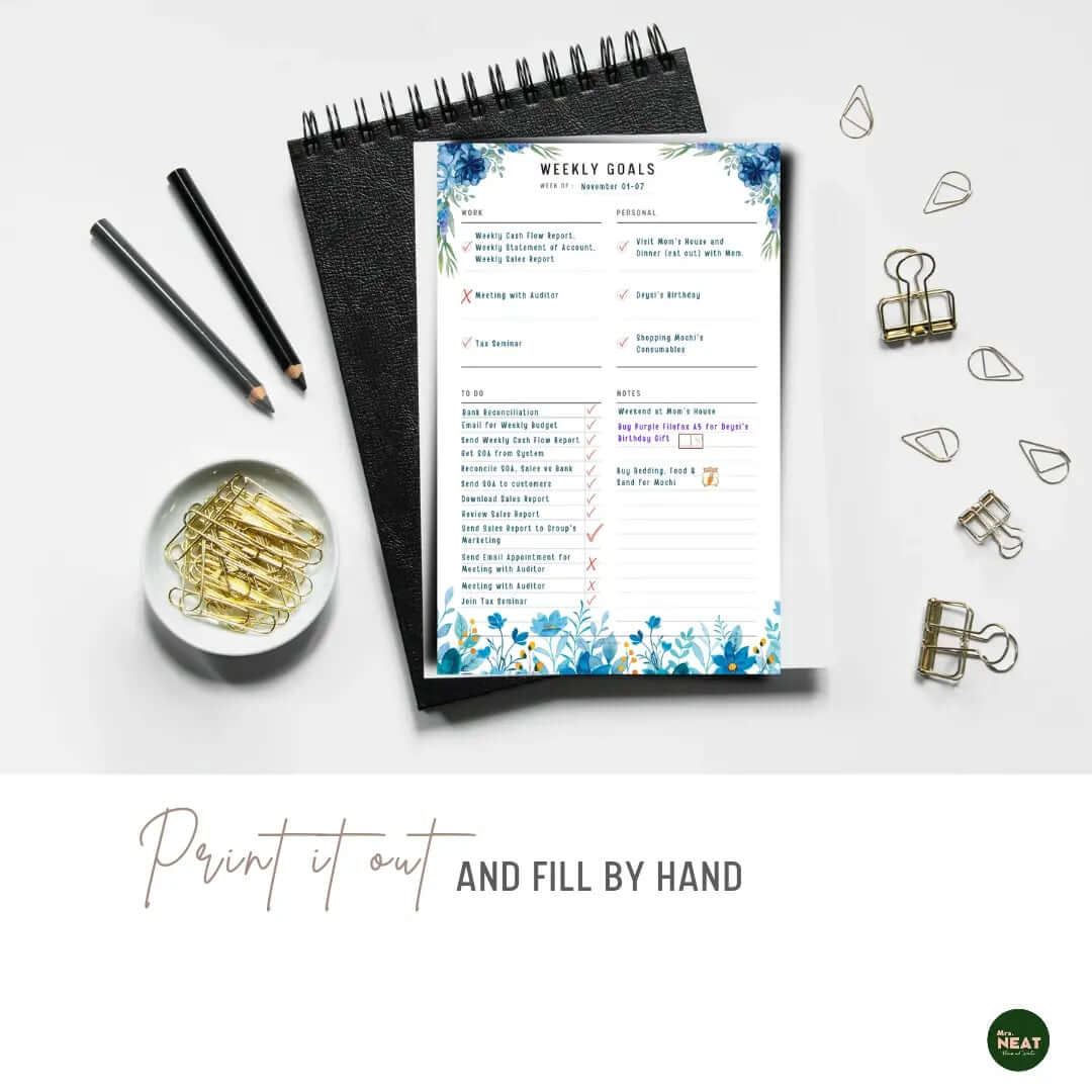 Blue Floral Weekly Goal Tracker Planner Printable printed out on the paper