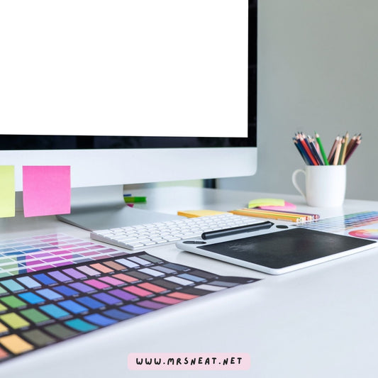 Blogger desk with a laptop, planner, and creative design resources for making printables