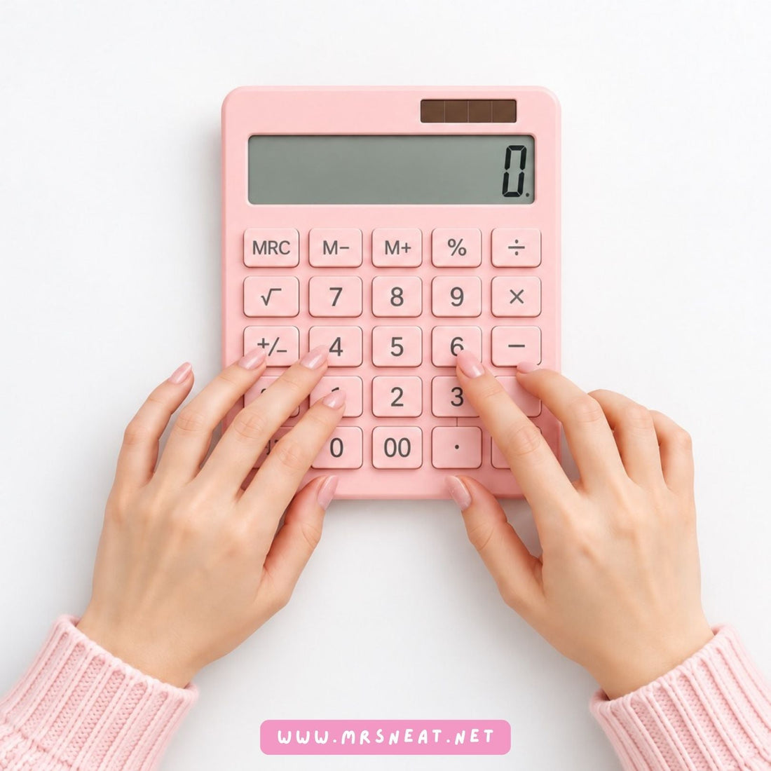 Hands using a pink calculator to calculate Print on Demand business costs and profits