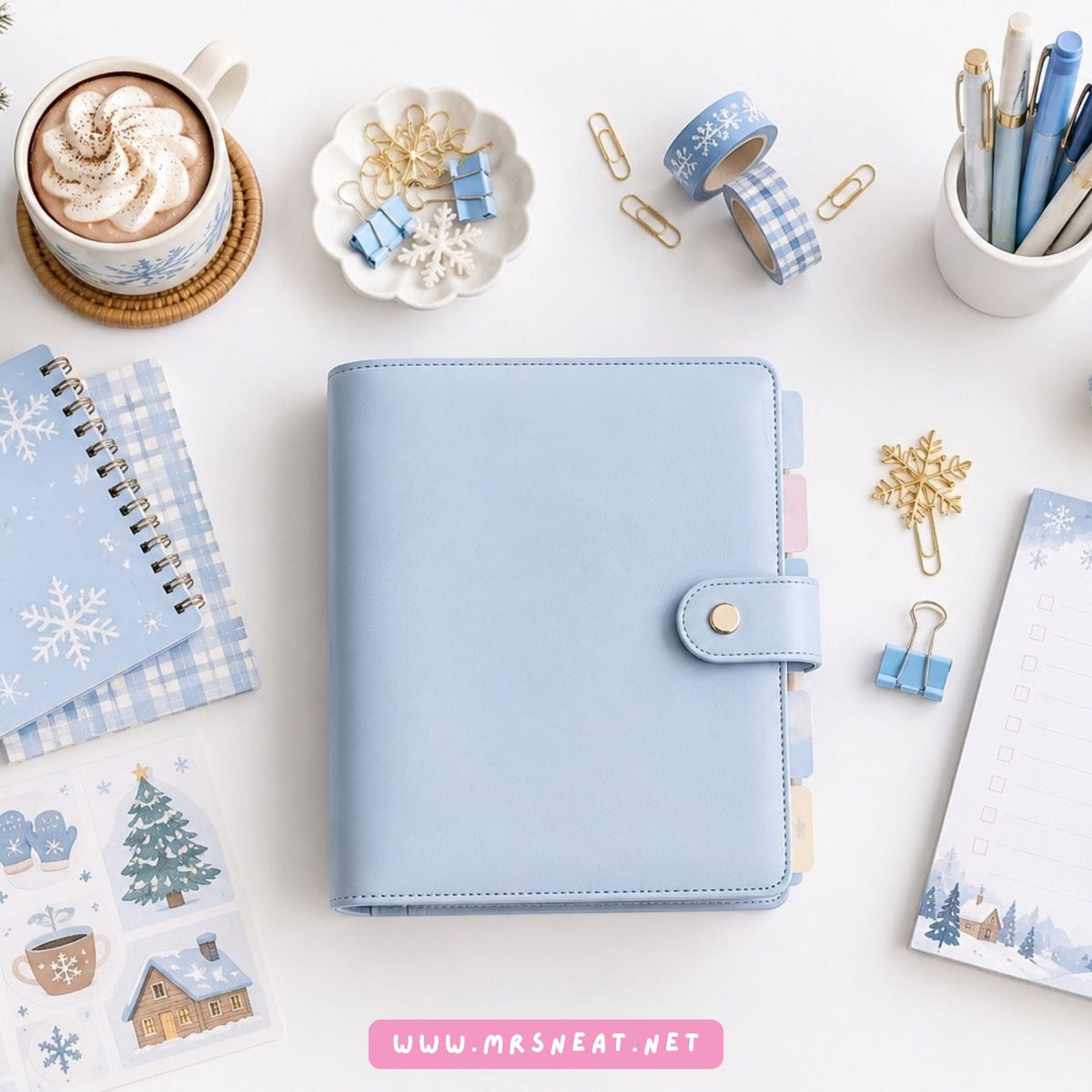 Winter planner collection cover featuring a light blue planner surrounded by snowflake stationery, Christmas decorations, coffee, and cozy winter accessories