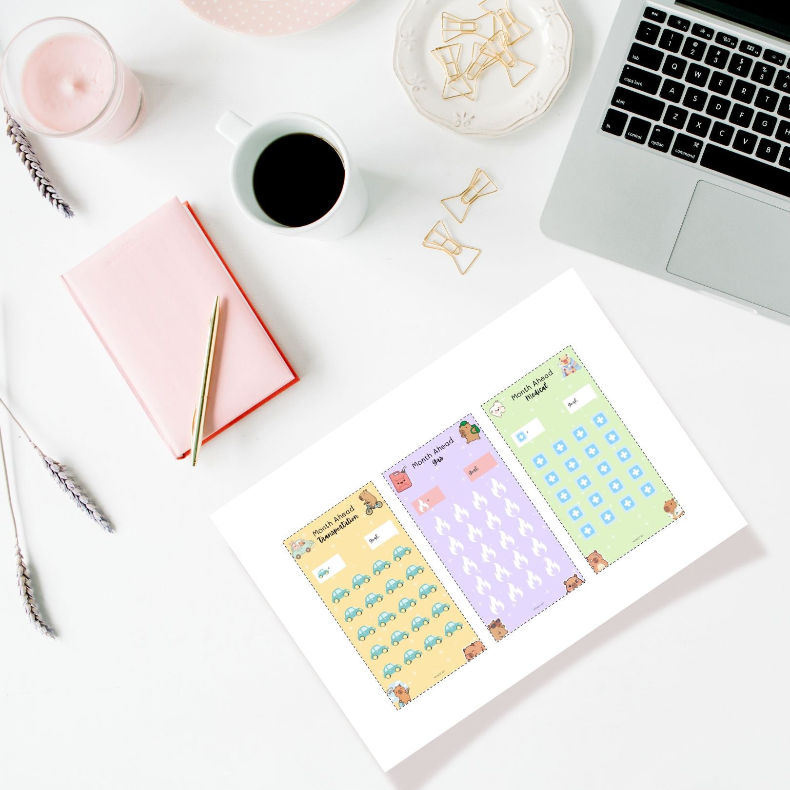 Colorful planner stickers on a white surface with a laptop, notebook, and coffee cup.