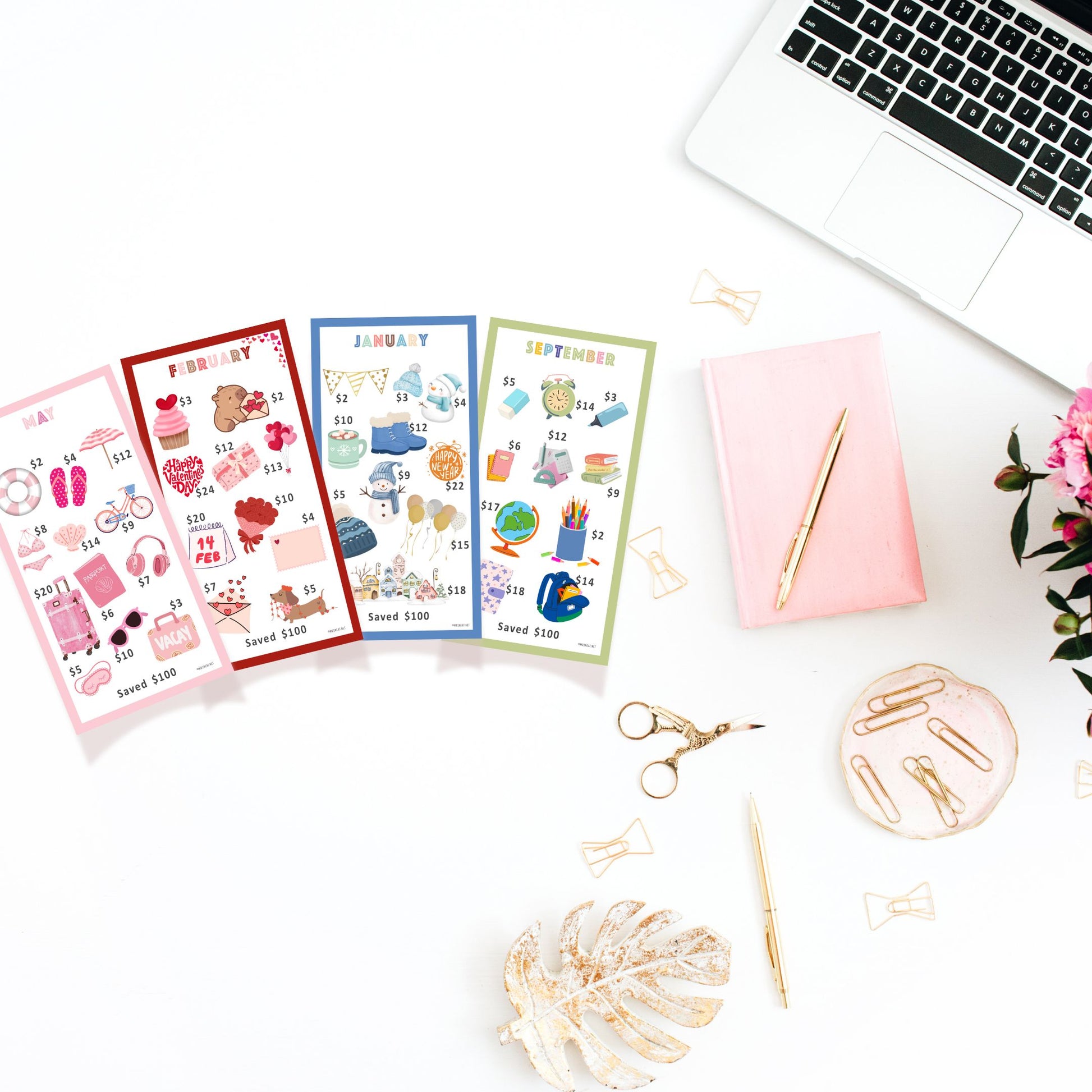 Colorful calendar sheets on a desk with a laptop, pen, and decorative items.