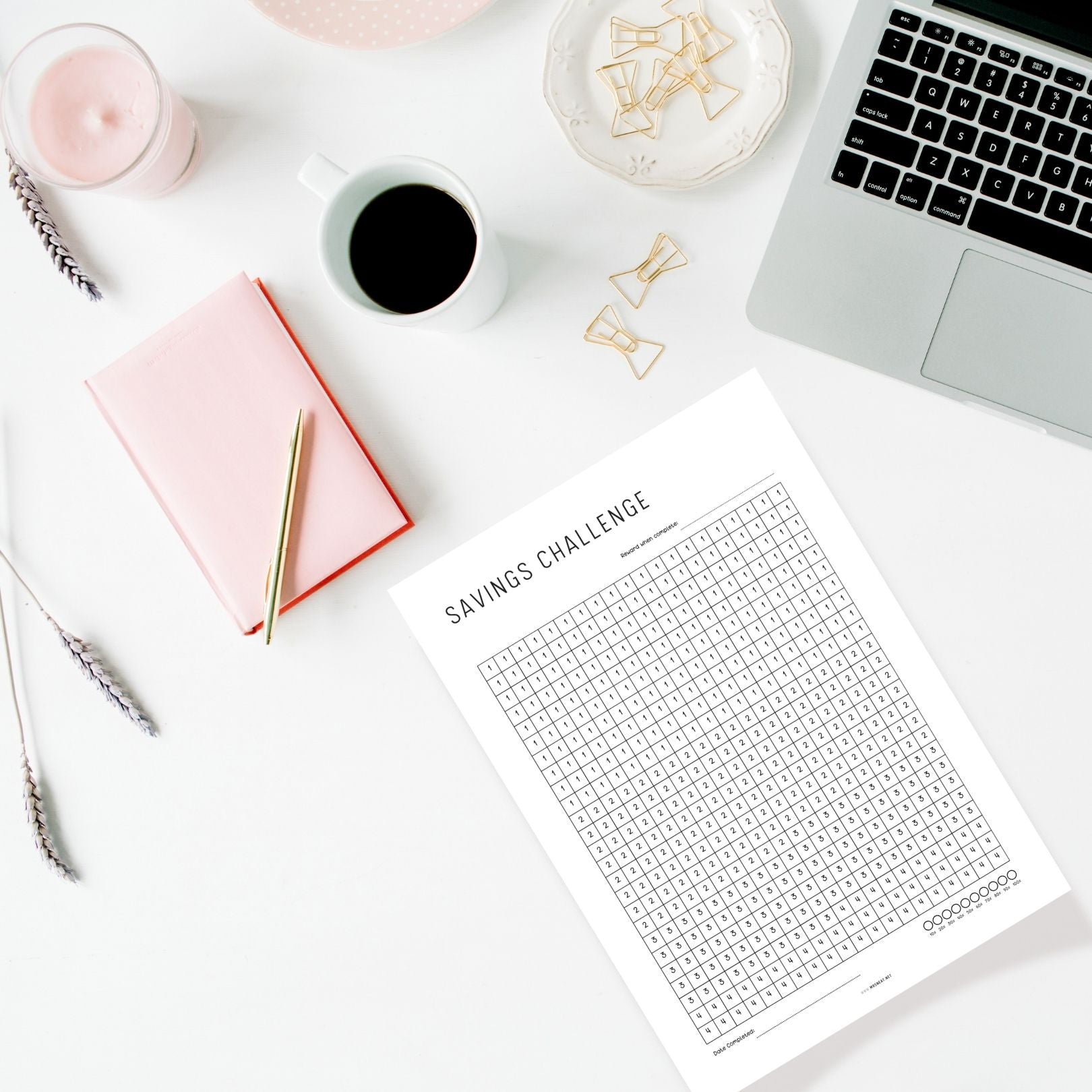 Minimalist printable budget planner on a desk with stationery for budgeting, saving money, and financial planning.