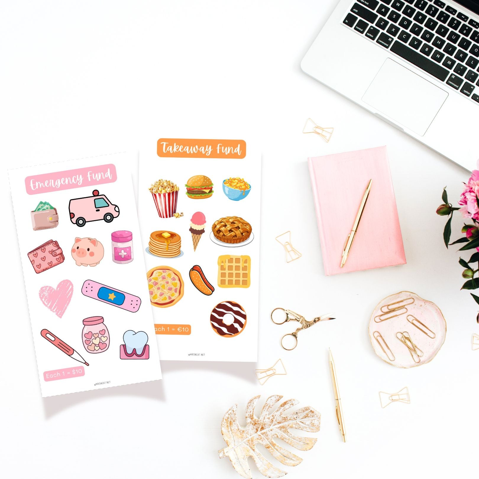 Two sheets of colorful stickers on a desk with a laptop, notebook, and stationery items.
