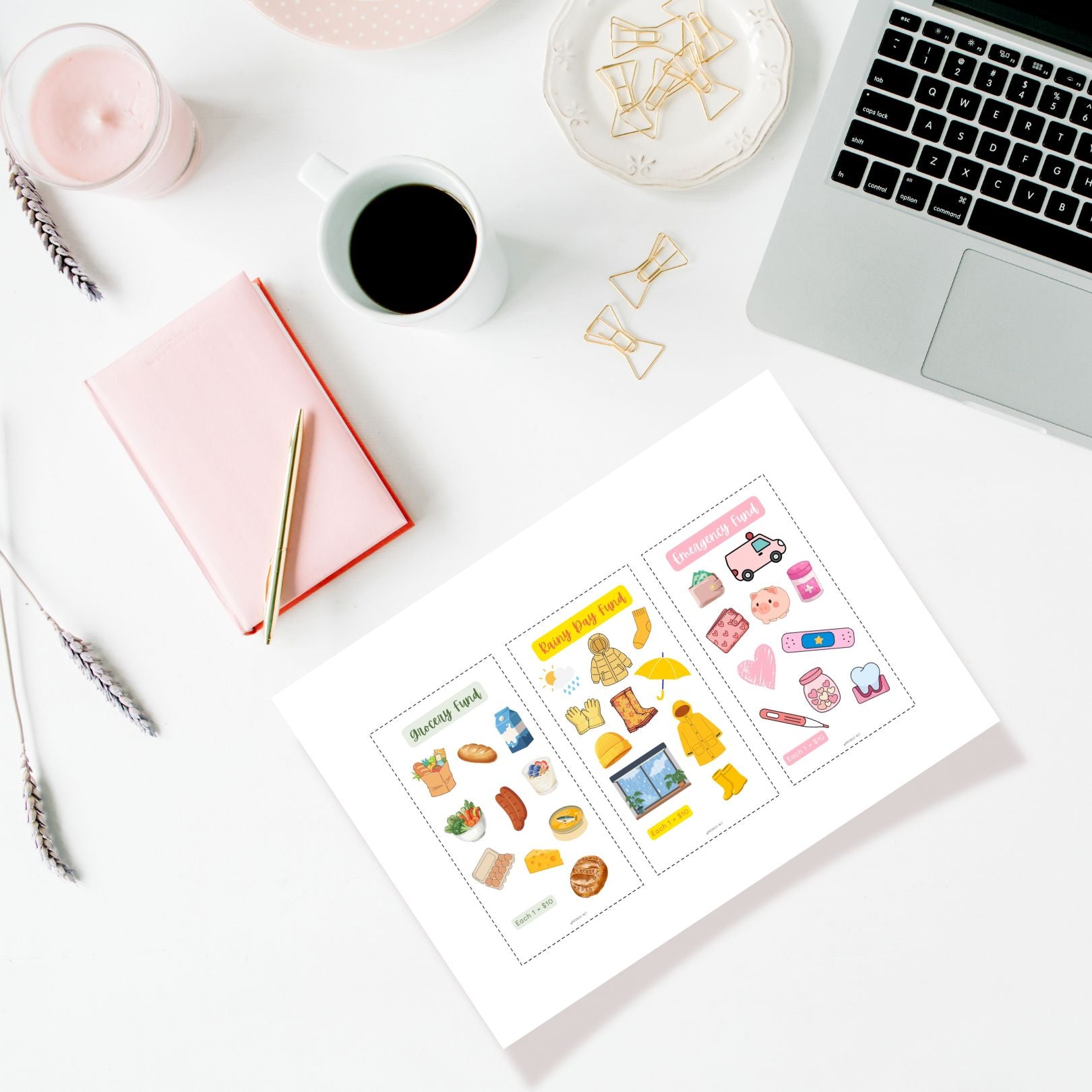 Sheet of stickers with various designs on a desk with a laptop and coffee.