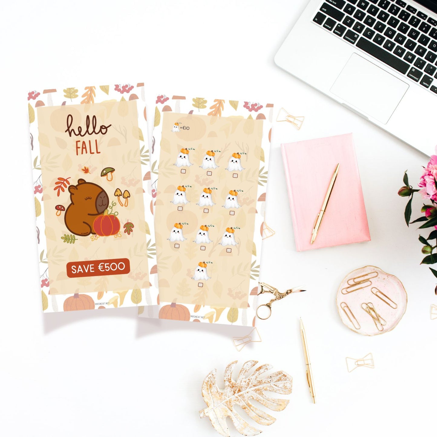 Two patterned bags on a desk with a laptop, pen, and flowers.