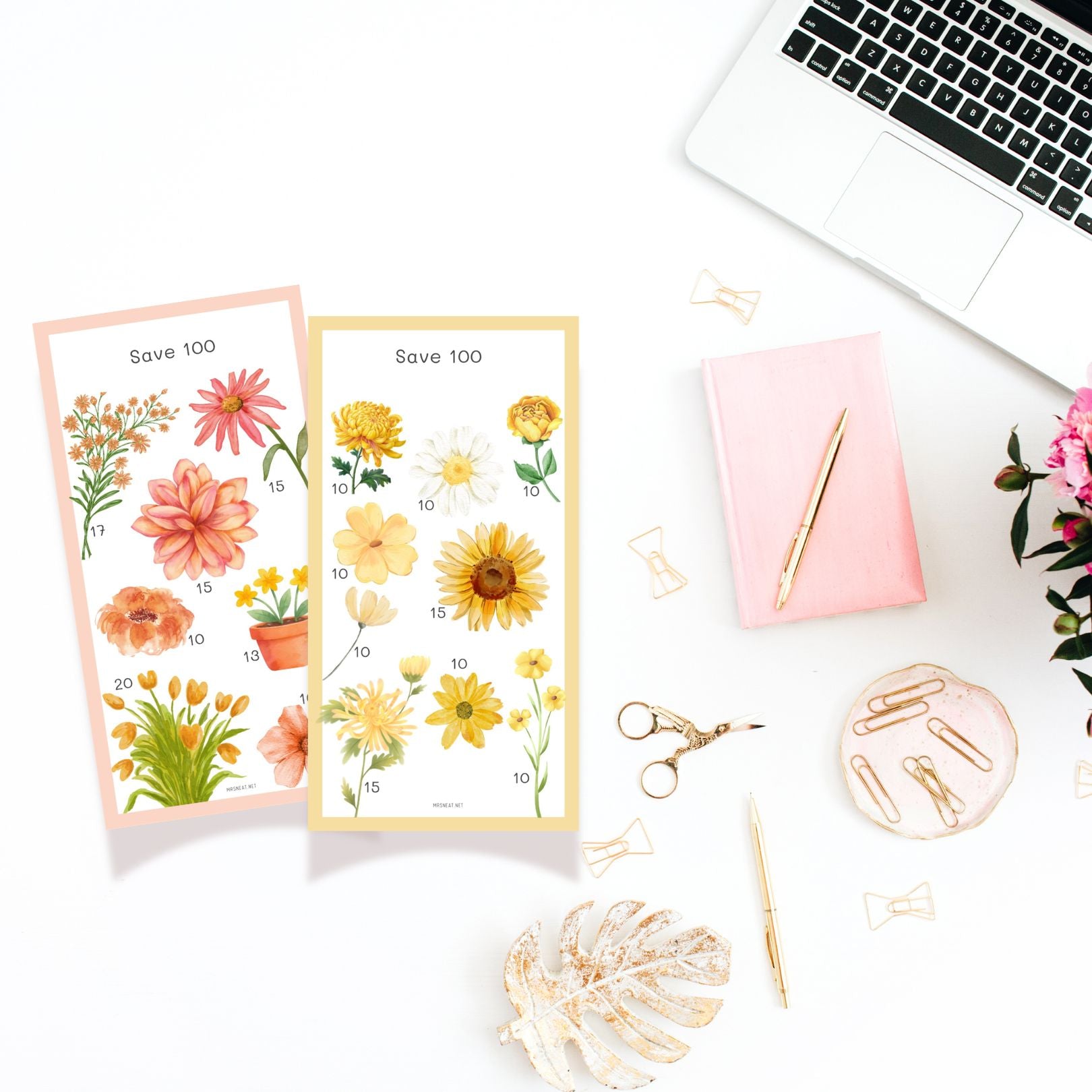 Floral-themed stickers on a desk with a laptop, notebook, and stationery items.