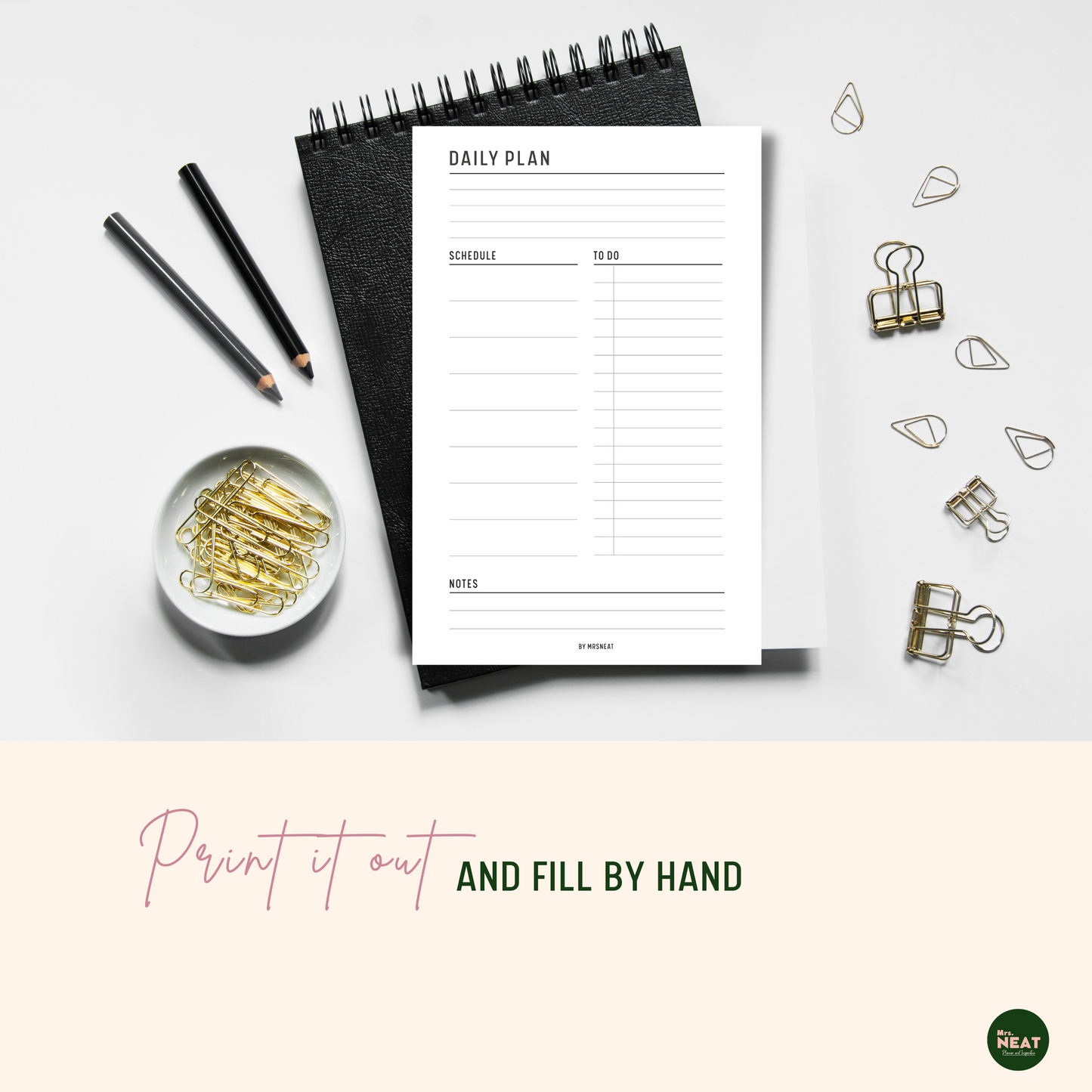 Daily Planner Printable printed out and put on the black book with aesthetic gold stationary